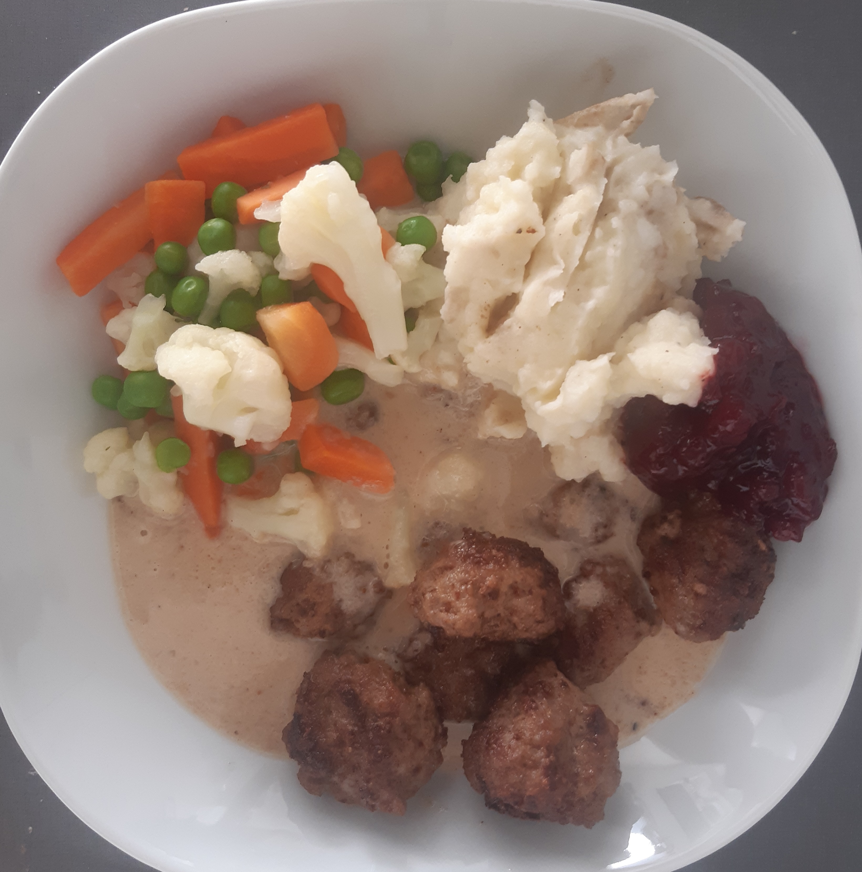 Bowl with meatballs, potato mash and boiled vegetables